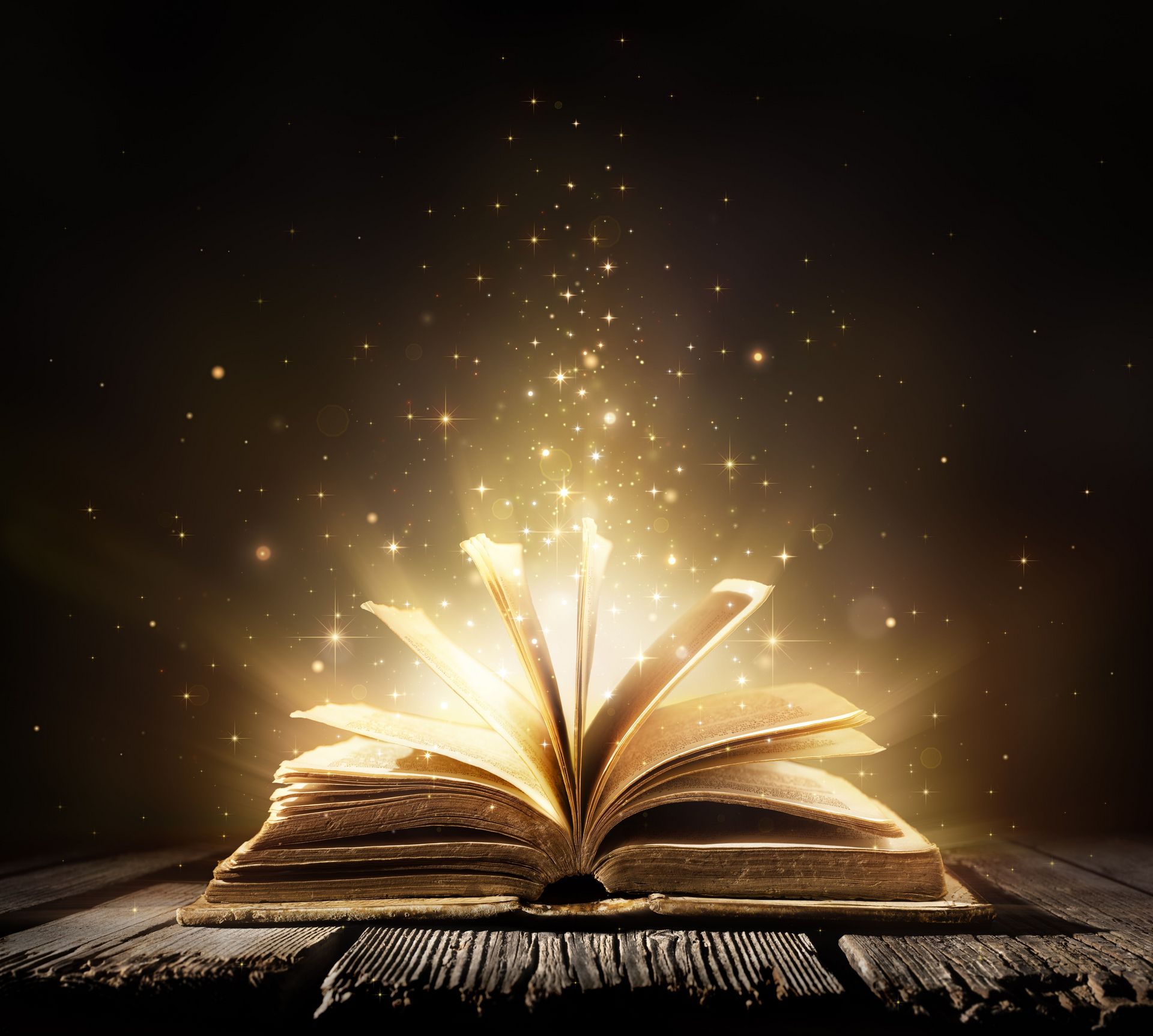 Open book on a sparkly black background